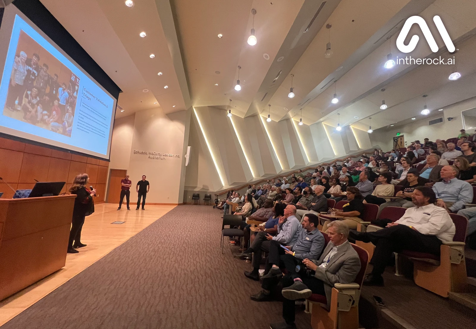 An AI InTheRock gathering with presenters and an audience at UA Little Rock