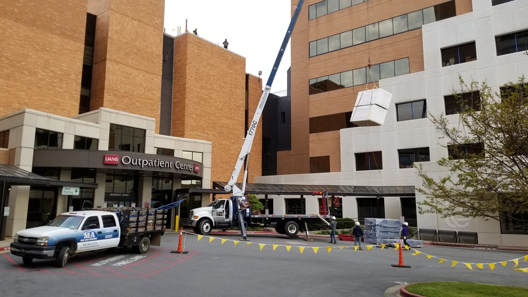 Crane hoisting roofing material to the UAMS Outpatient Center roof.