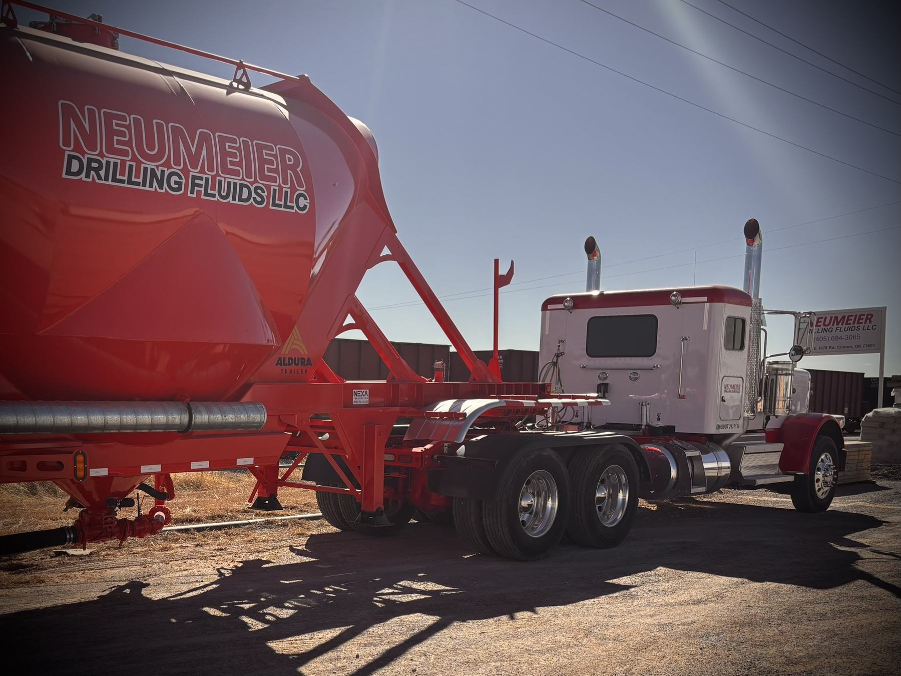 Neumeier pneumatic bulk trailer and tractor at the company yard.